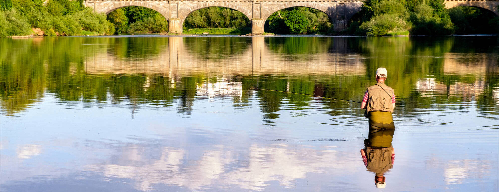 Man fishing in the River Tweed Man fishing in the River Tweed